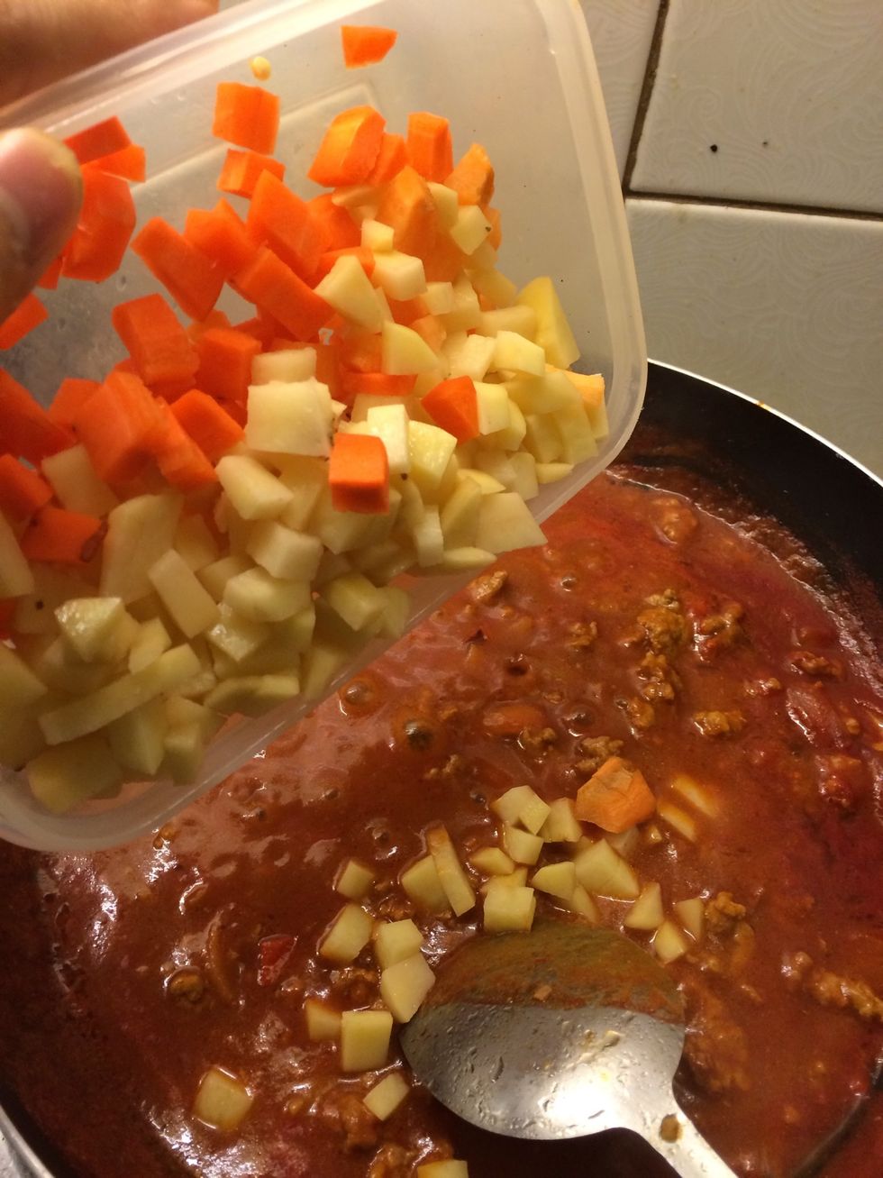 Add the potatoes and carrots. Stir and bring to a boil.