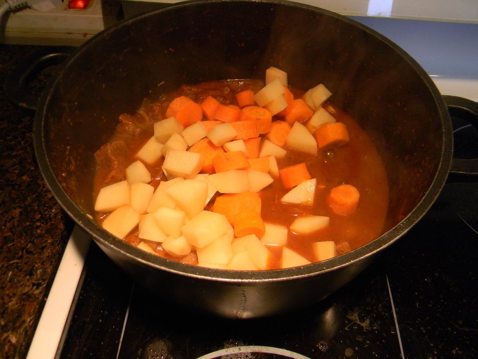 Add the potatoes and carrots to the stew.