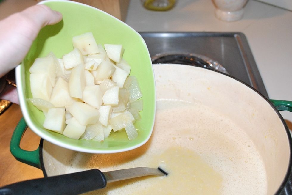 Add the potatoes and onions back into the pot, as well as the last two cans of corn - stir to combine and cook just enough to reheat