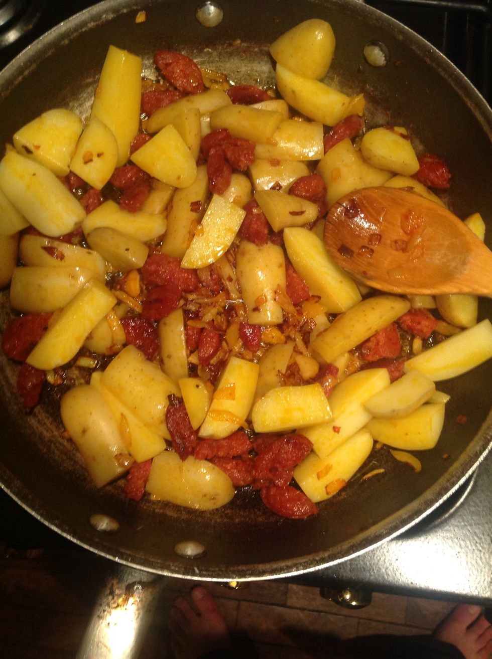 Add the potatoes to the chorizo and onions. Mix everything together