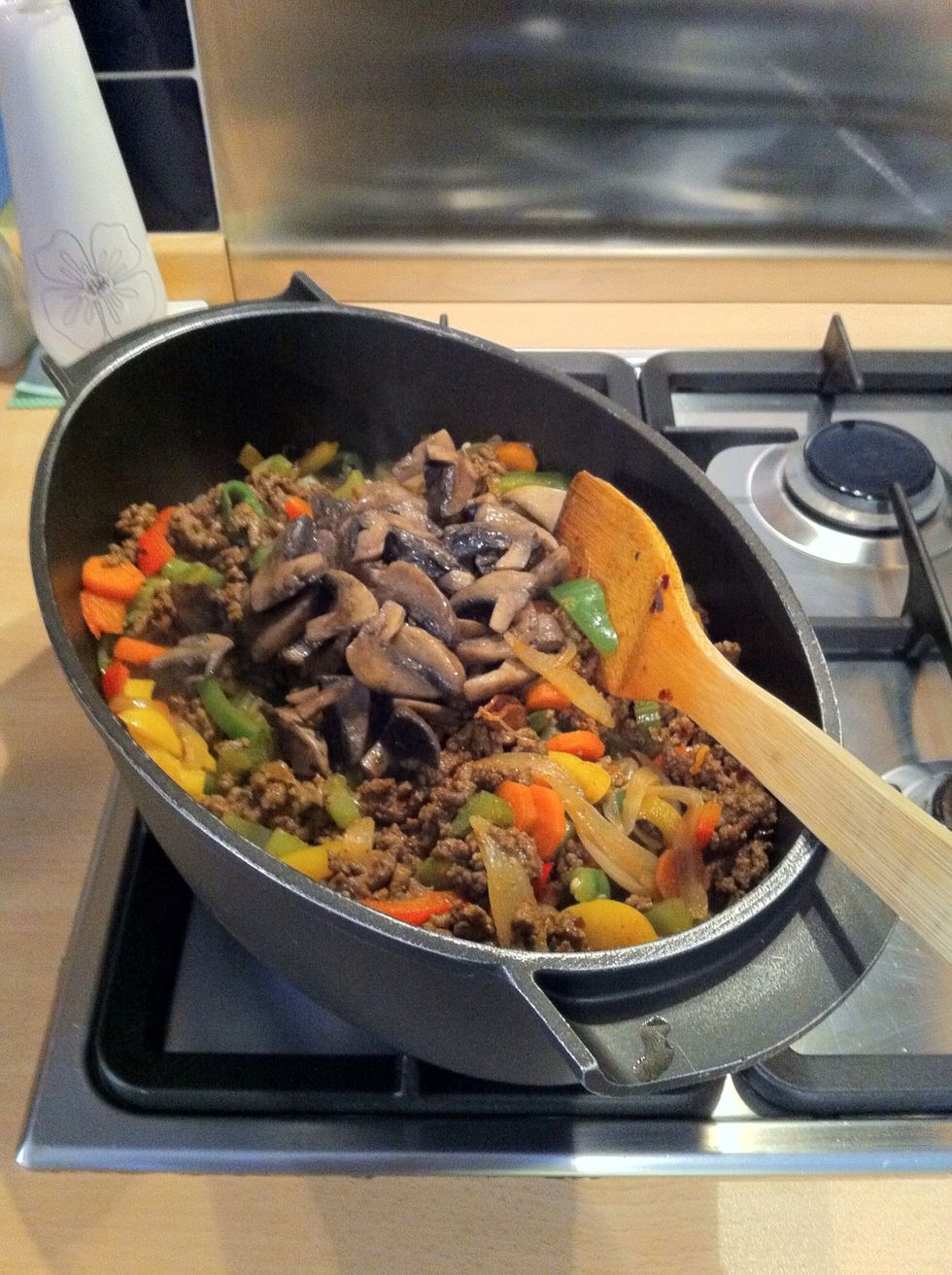 Add the previously cooked mushrooms.