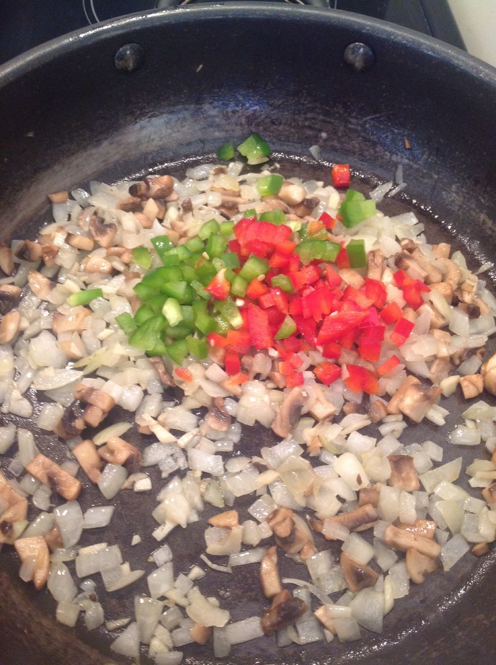 Add the red and green peppers and continue to fry for 3-4 minutes.