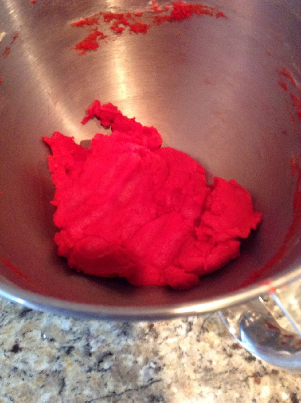 Add the red paste food coloring to half of the dough
