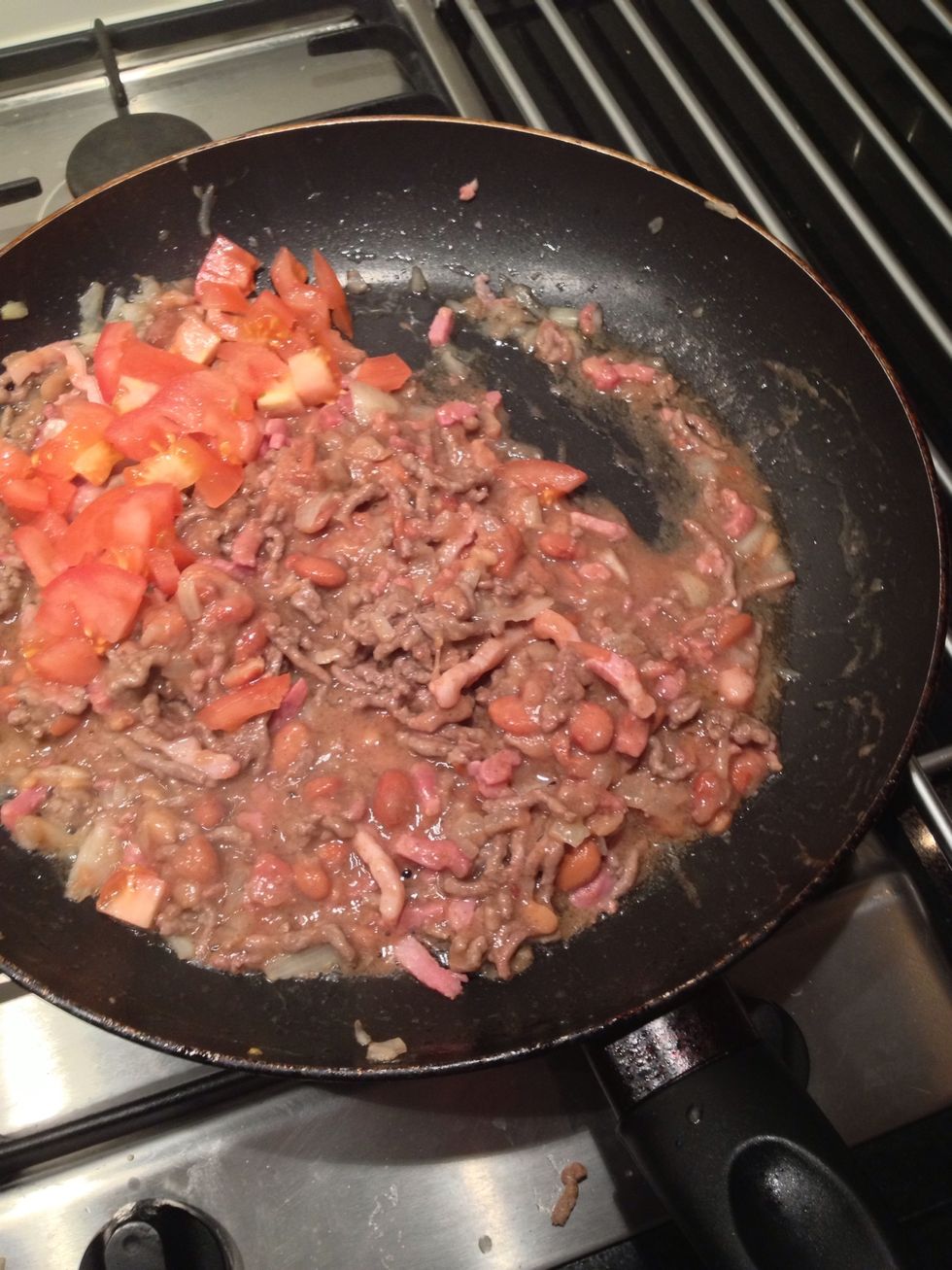 Add the refried beans and tomatoes (chopped of course)