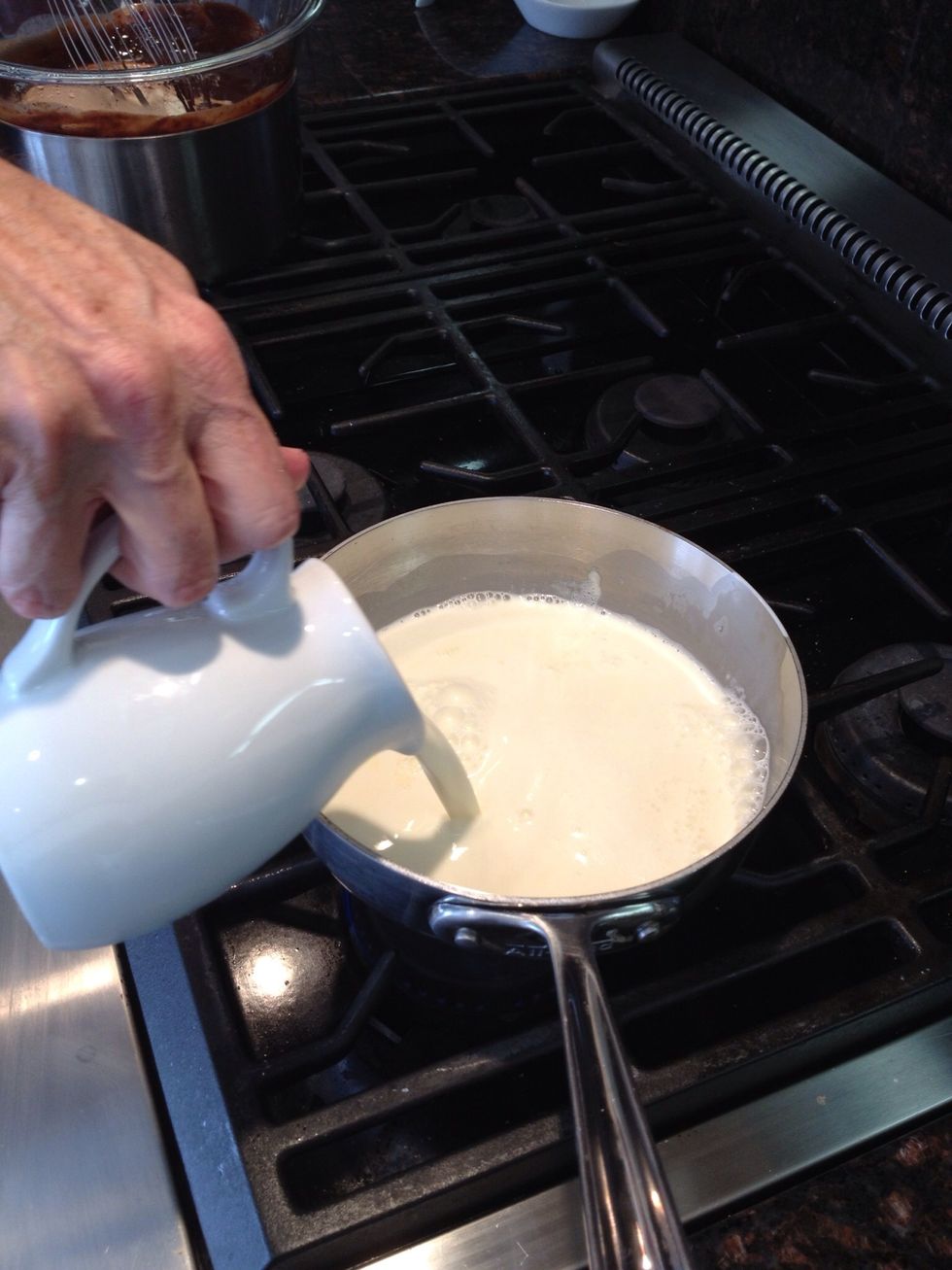 Add the rest of the cream into the pan of warming milk.