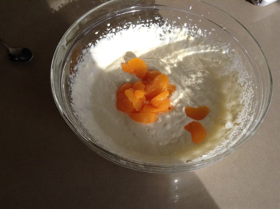 Add the rest of the drained oranges to the mixture