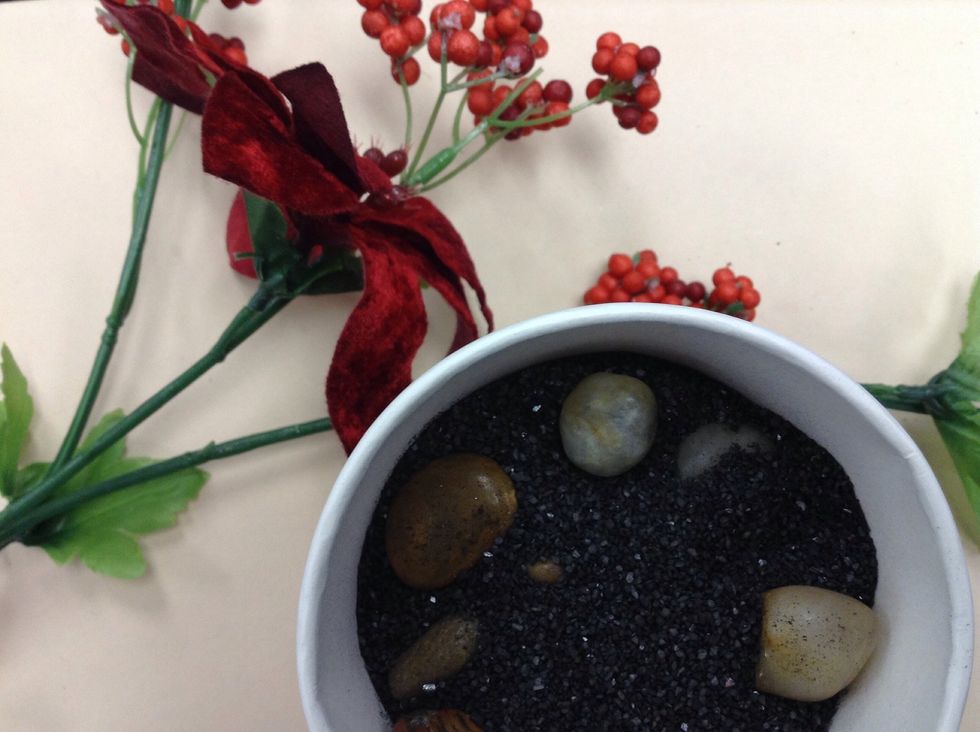 Add the rest of the sand a few remaining rocks. Prepare flowers/plants.