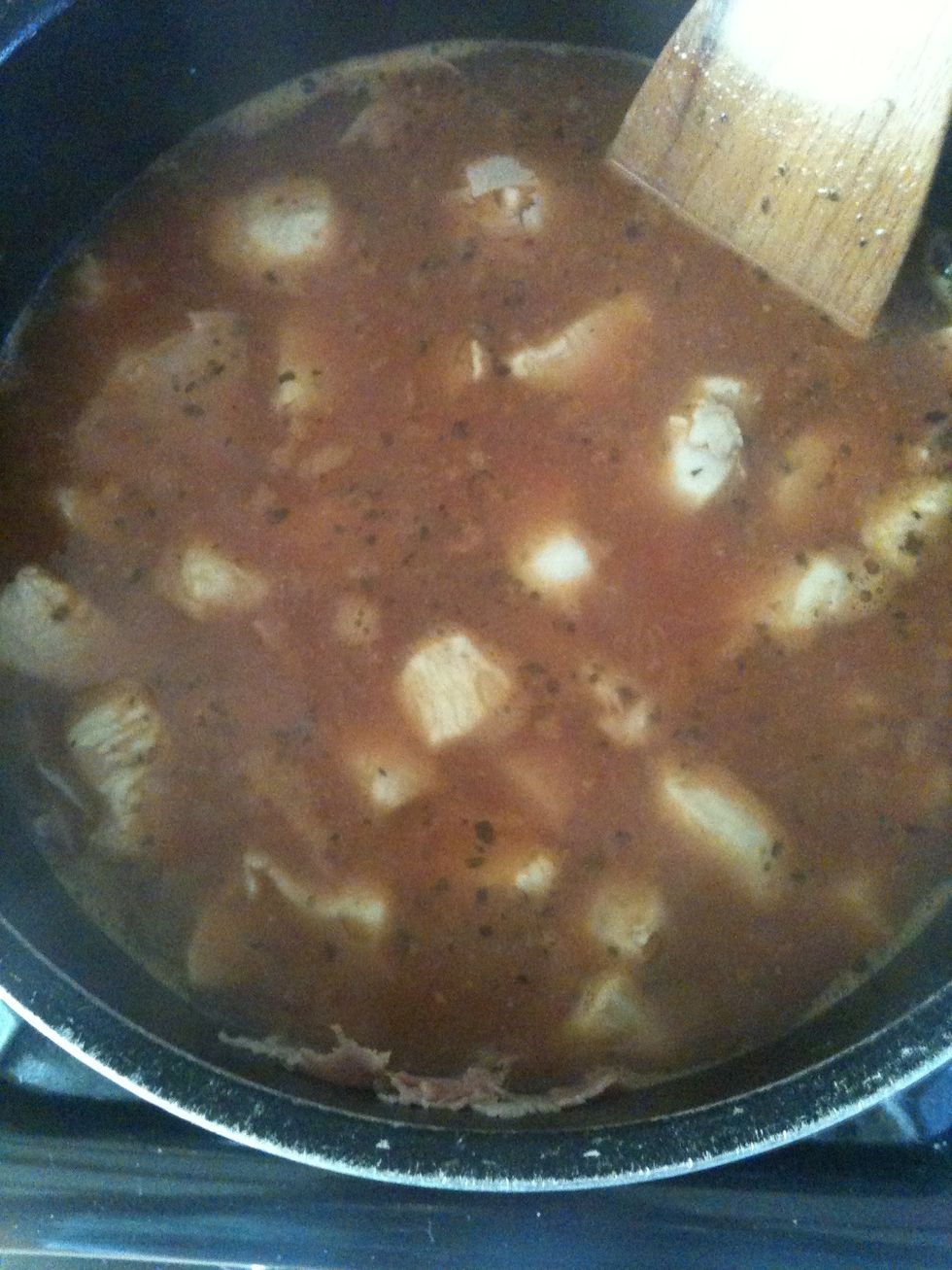 Add the rest of the stock, the chopped tomatoes, the rice and the thyme (I use basil... I think) :P