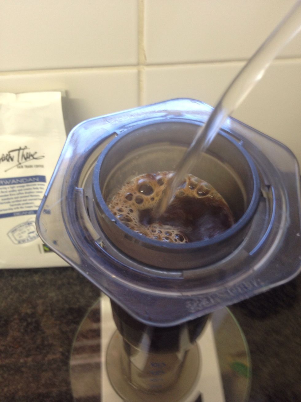 Add the rest of the water until your brew weighs 230g. Once this is done, you should have 25 - 30 seconds brew time left. Keep an eye on the timer!