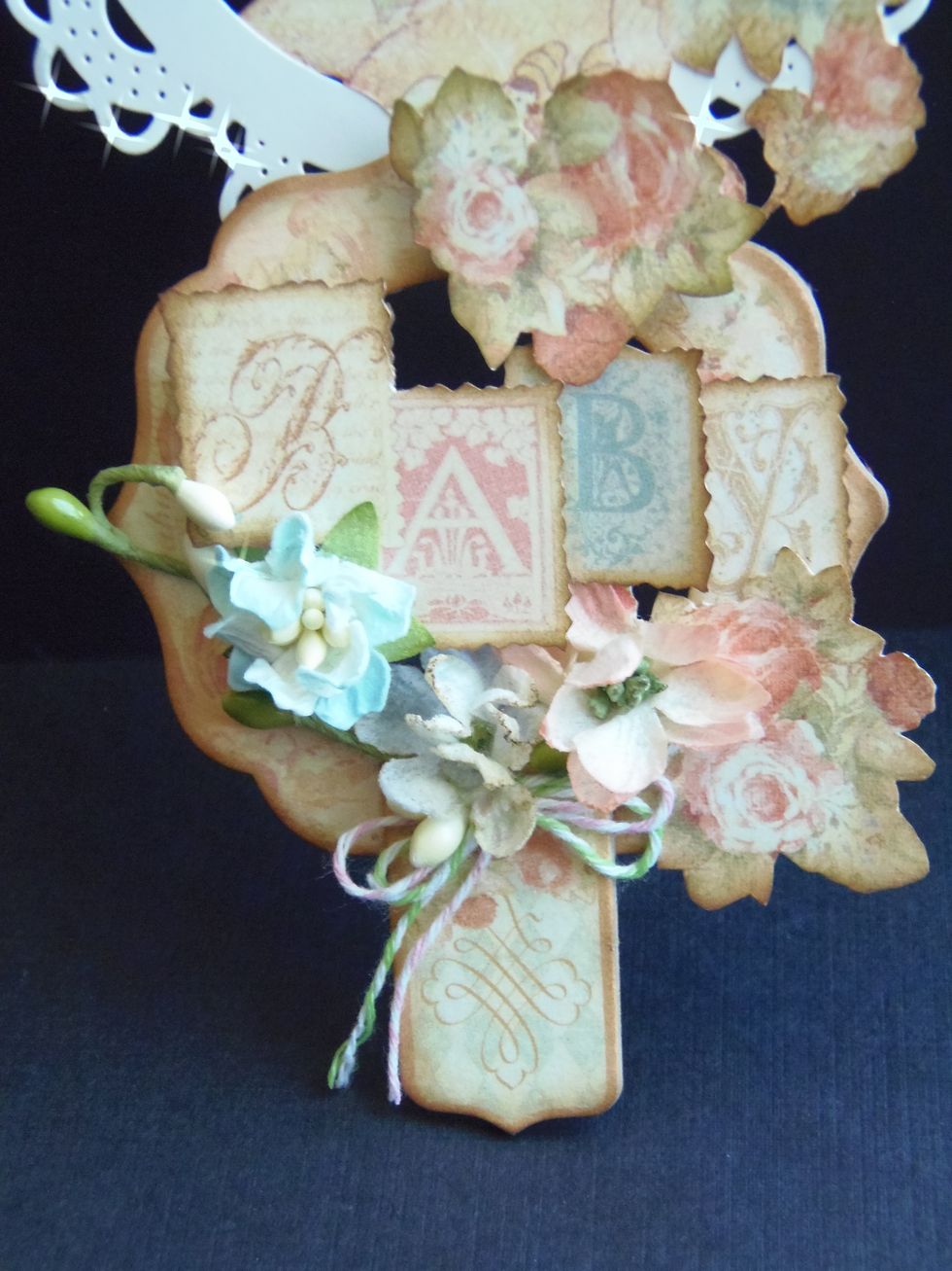 Add the rest of your fussy cuttings, flowers and other embellishments to finish decorating your chipboard frame.