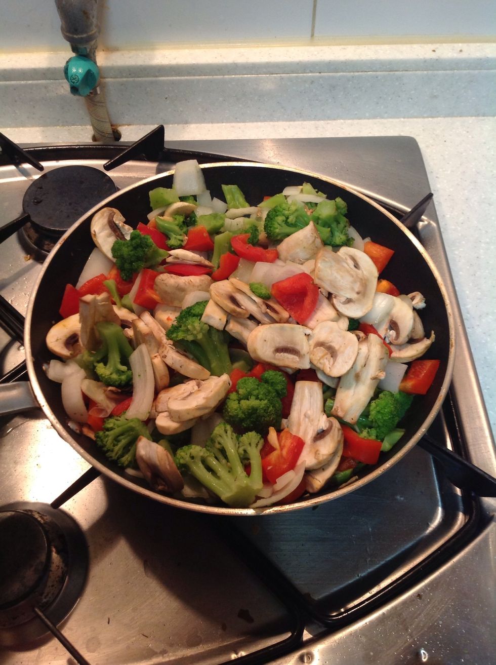 Add the rest of your veggies. Cook for about 3 mins then add a little salt and pepper followed by 2 tablespoons of sesame seed oil, olive oil and soy sauce (2tblsps each) cook for an additional 3mins