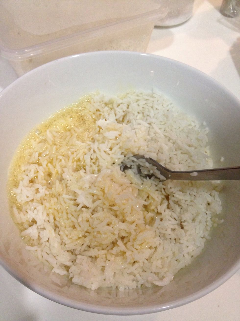 Add the rice into the whisked egg. Prefer overnight rice as they won't lump together.