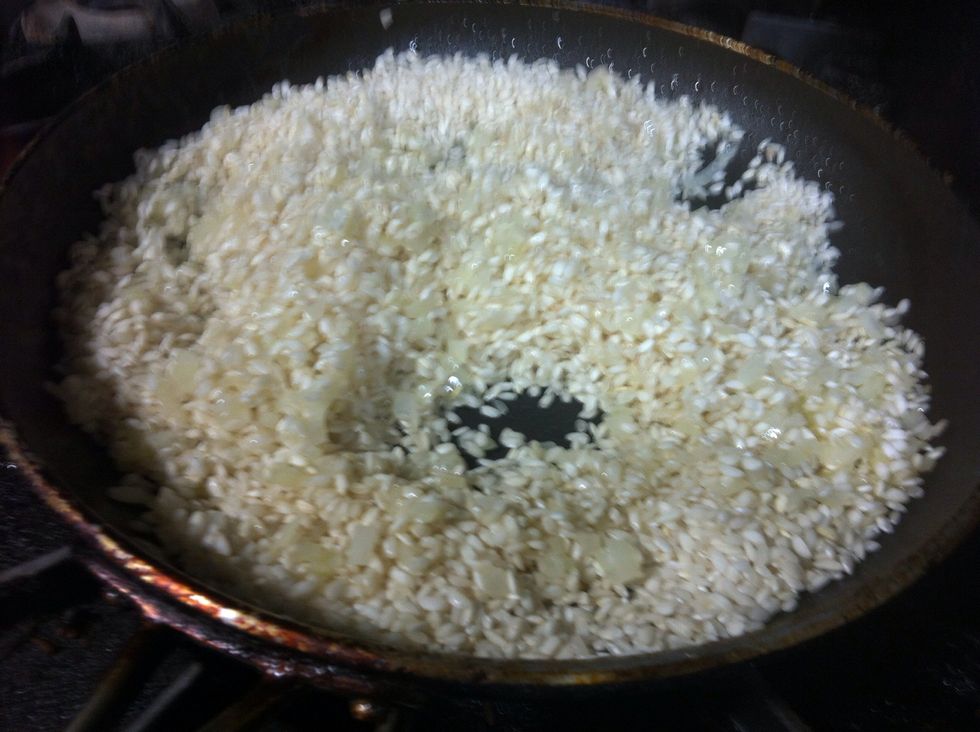 Add the rice. Saut\u00e9 until coated with the fat.