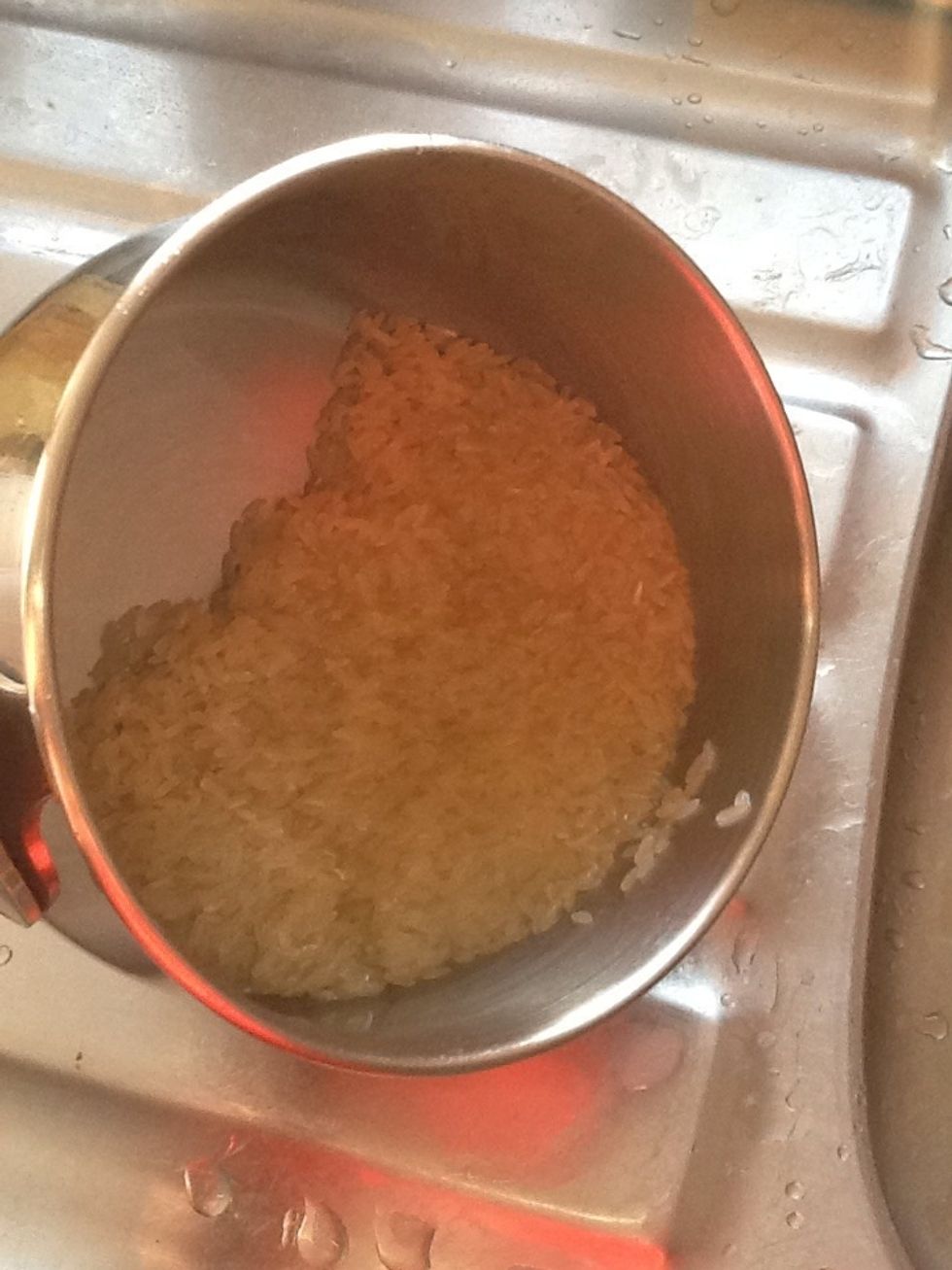 Add the rice to a pan and wash until the water is roughly clear.