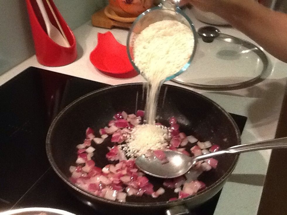 Add the rice to the cooked onion and stir until coated in oil and it looks translucent.