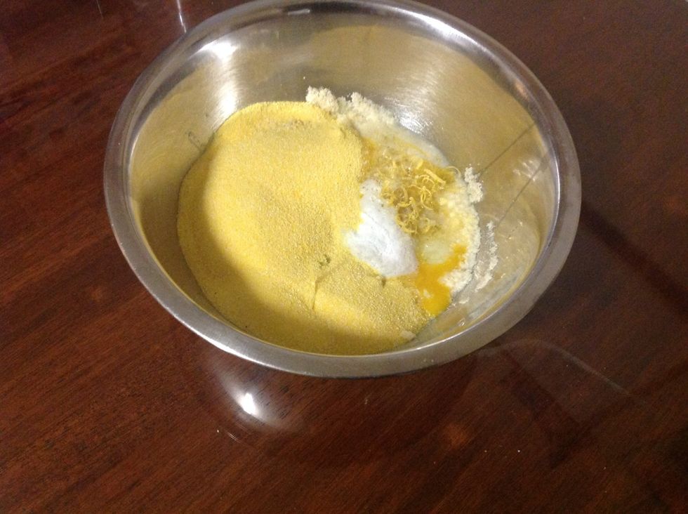 Add the rind and juice of 2 lemons, polenta and the baking powder to the bowl