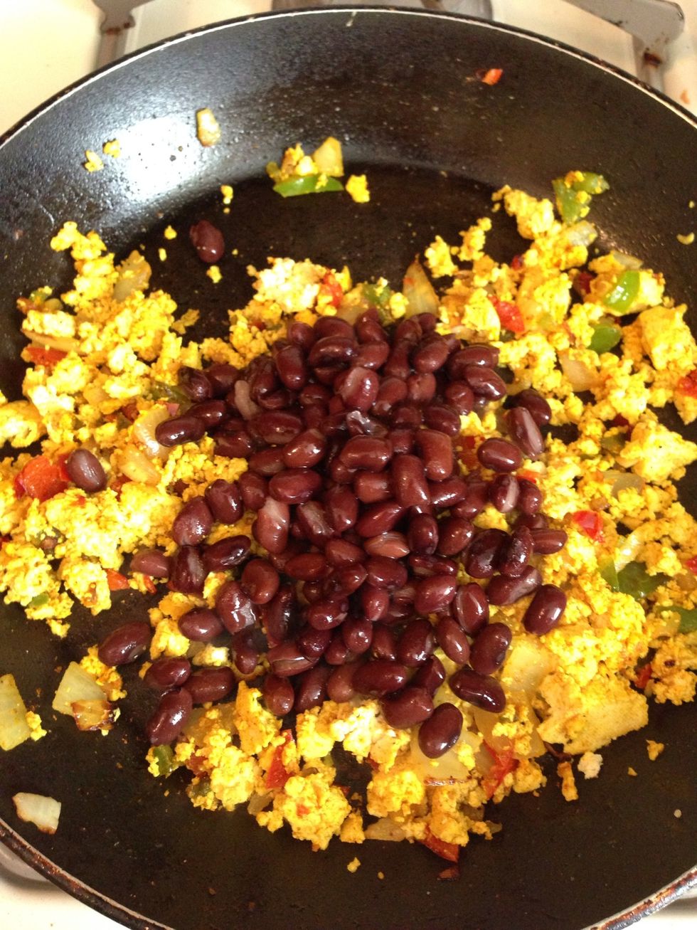 Add the rinsed and drained black beans into the tofu mixture. Stir