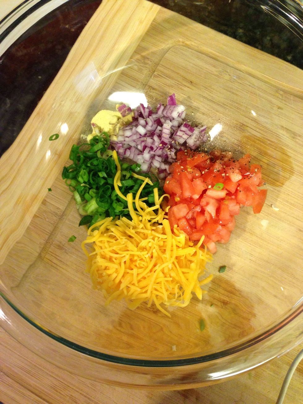 Add the salt, pepper, Goya seasoning and cheese to bowl.