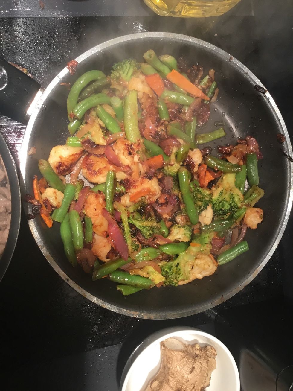 add the same amount of sesame oil to the veggies. Turn up the heat a bit.