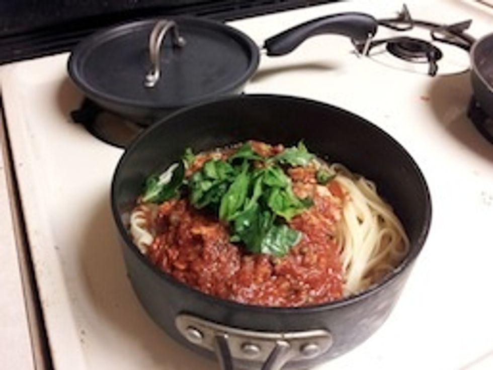 Add the sauce and the reserved cooking water and toss. Season with pepper and garnish with more basil.