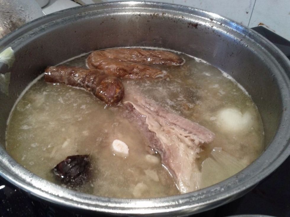 Add the sausages and potatoes to the pot with the remaining beef and pork.