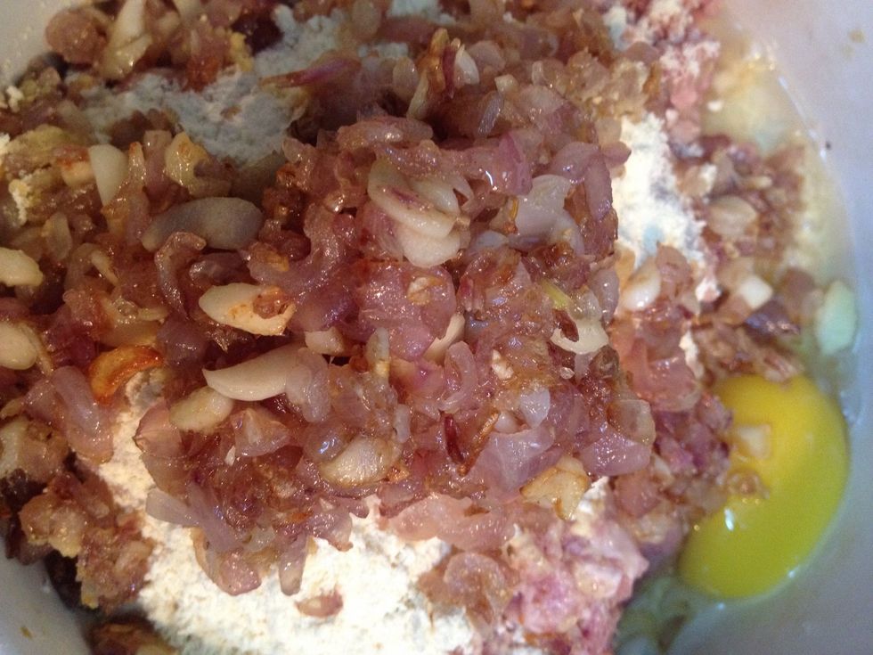 Add the saut\u00e9ed shallots and garlic to the minced meat