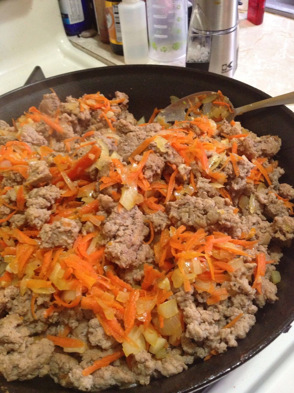 Add the saut\u00e9ed vegetables back into the pot with the meat