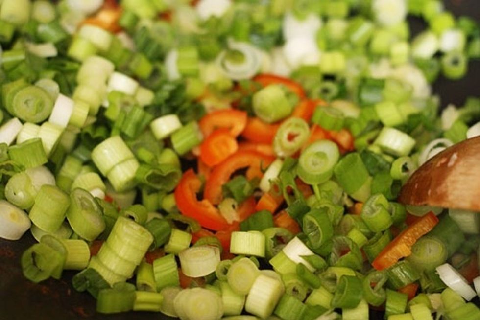 Add the scallions, chili and garlic to the wok.