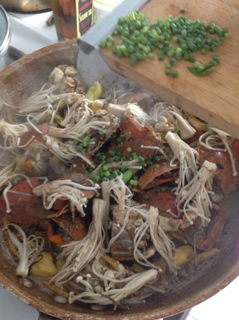 Add the separated enokis, and garlic scapes.