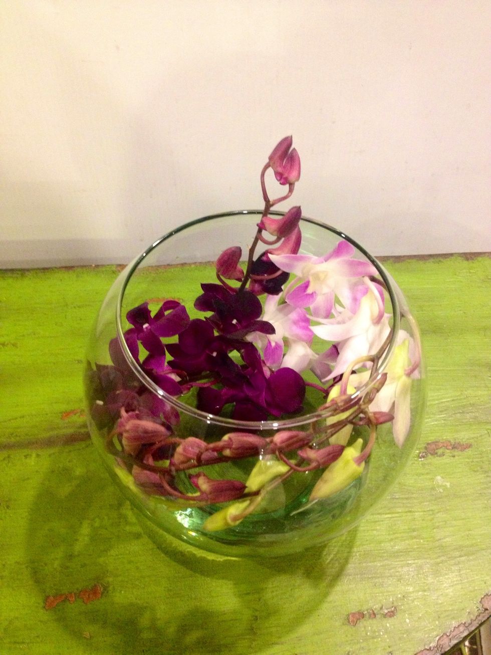 Add the shorter stems to create a "grid" so as to hold the longer portion. Add the taller piece so it appears just above the lip of the bowl.