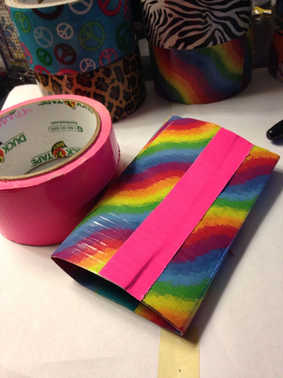 Add the sides together to create a pouch but make sure ur phone can slid in and out with a breeze (it may take a few tries to get it right)