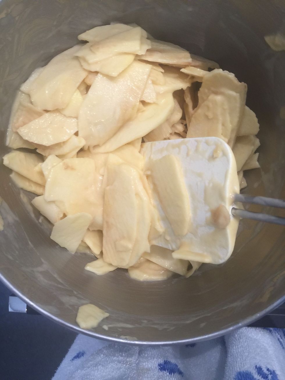 Add the sliced apples and mix delicately until all the apples are coated