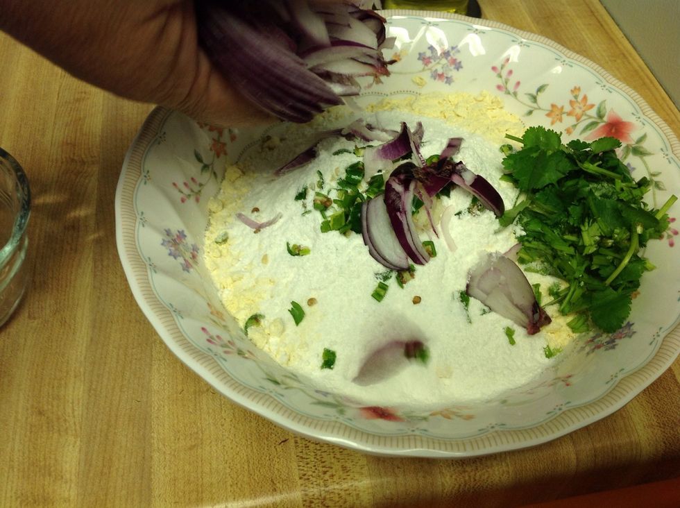 Add the sliced onions, green chillies and cilantro