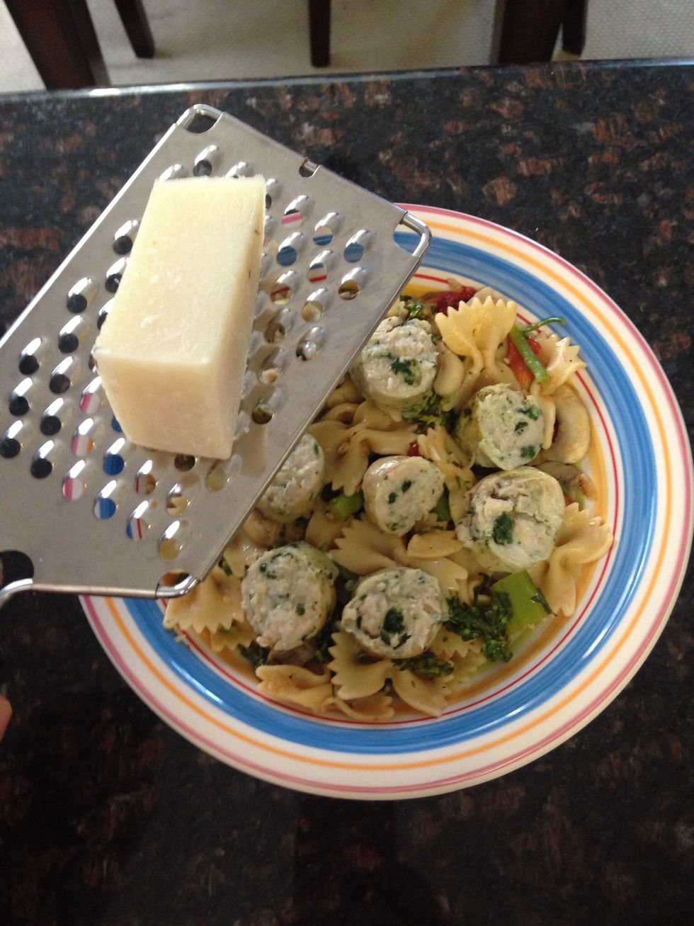 Add the sliced sausage to the pasta and serve into pasta bowls. The finishing touches, grate some fresh Romano Locatelli Cheese on top. This gives it the perfect "bite" to the dish.