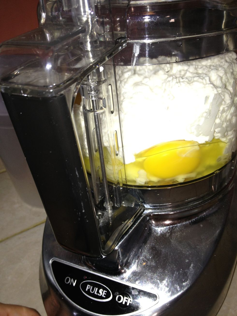 Add the small curd cottage cheese, and three eggs to the mozzarella. I also sprinkled some salt, pepper and italian seasonings. Pulsate!! Lol or blend whatever you prefer to call it;)