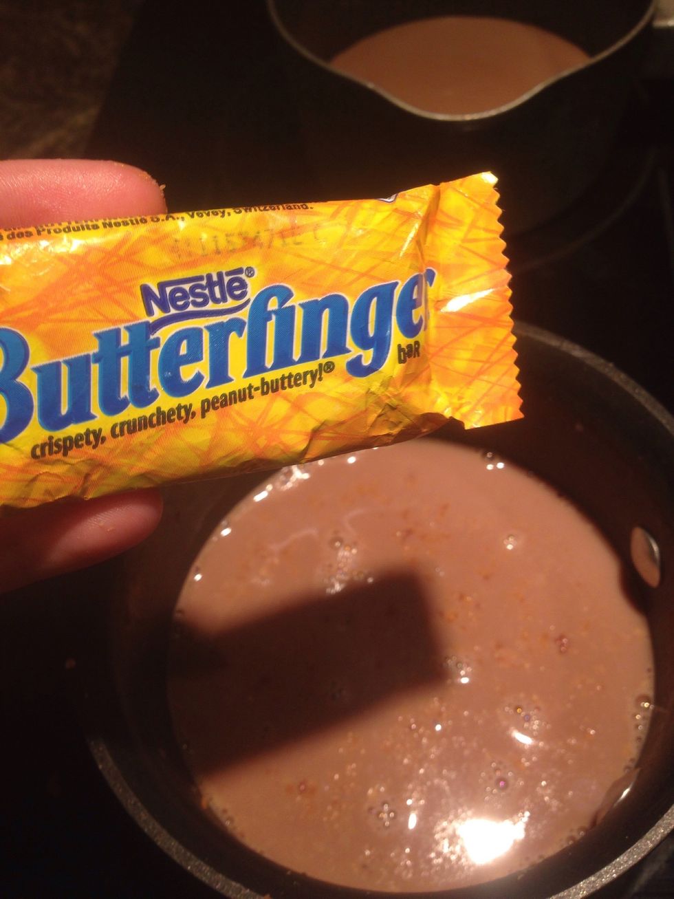 Add the smashed Butterfinger to the hot chocolate (you will need to turn the burner up a little bit so that the hard part of the Butterfinger will melt)