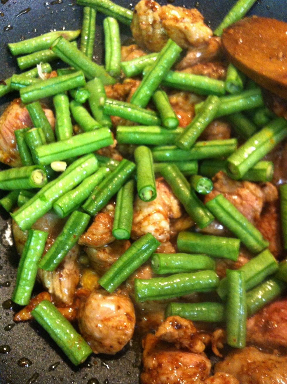 Add the snake beans mixed up together , then add fish sauce, sugar and milk.