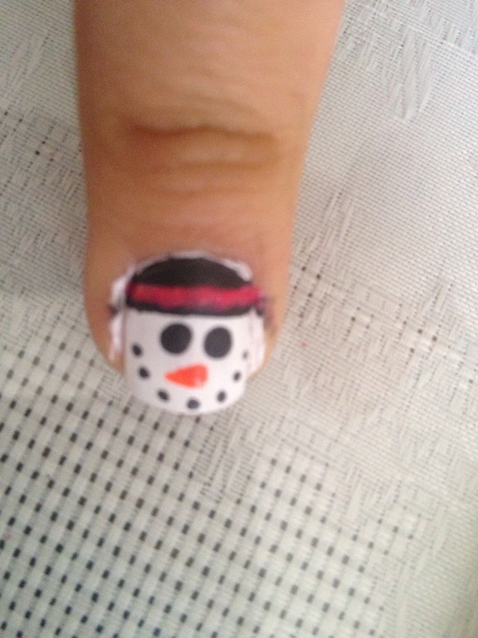 Add the snowman's nose with the Orange nail polish.