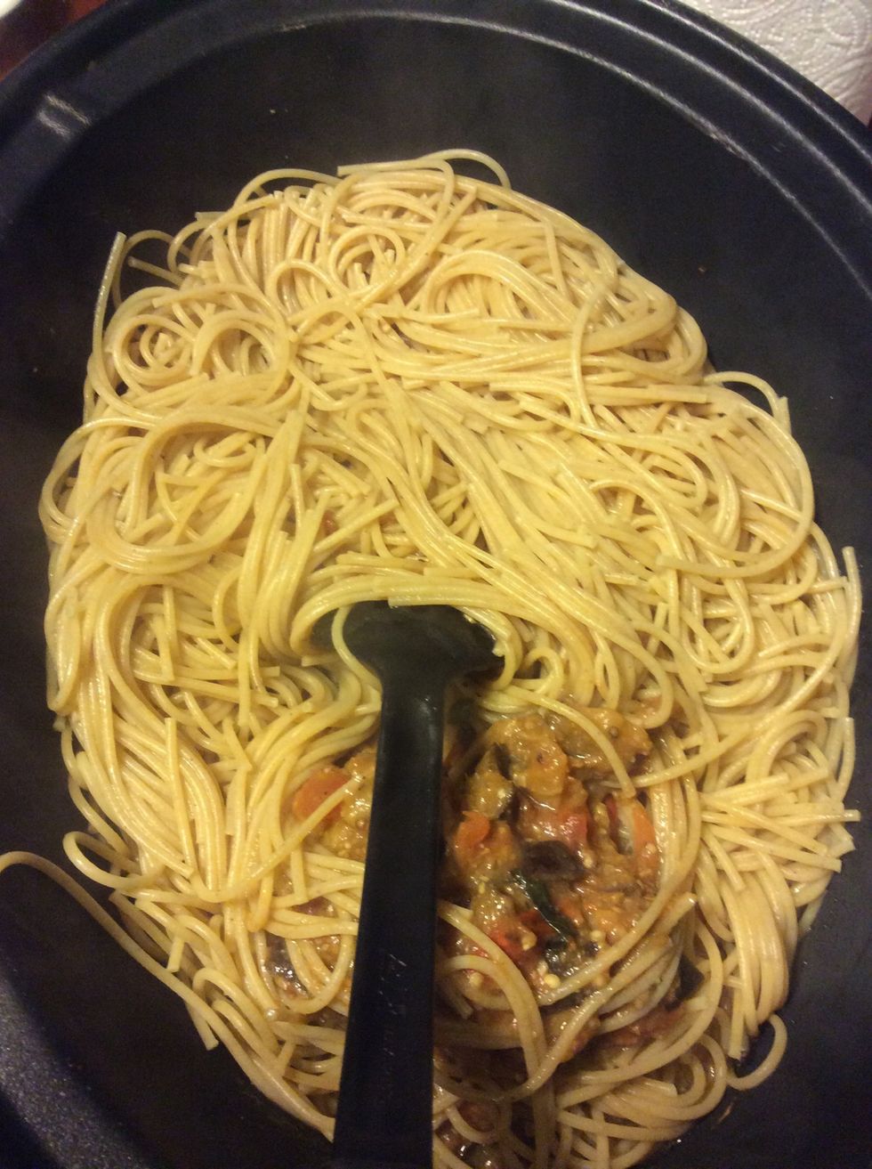 Add the spaghetti to the sauce and toss well, adding an extra splash of the reserved cooking water to loosen, if needed.