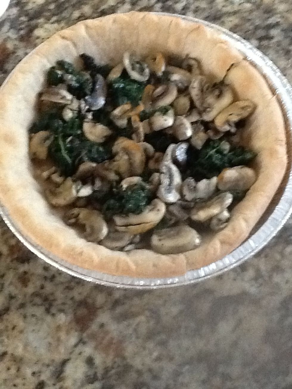 Add the spinach and mushrooms to pie crust