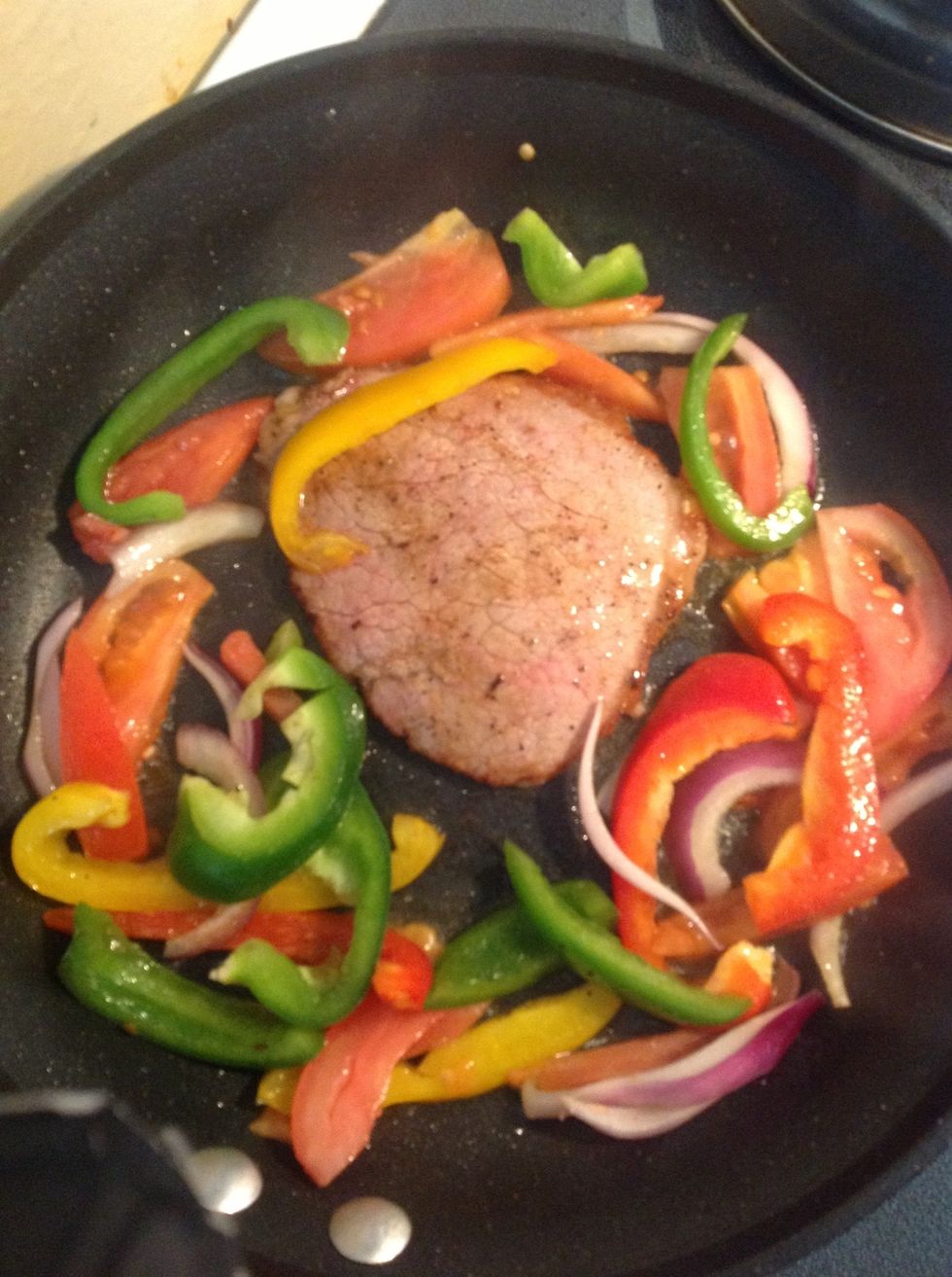 Add the steak into the pan. Flip when one side is browned. Add vegetables.