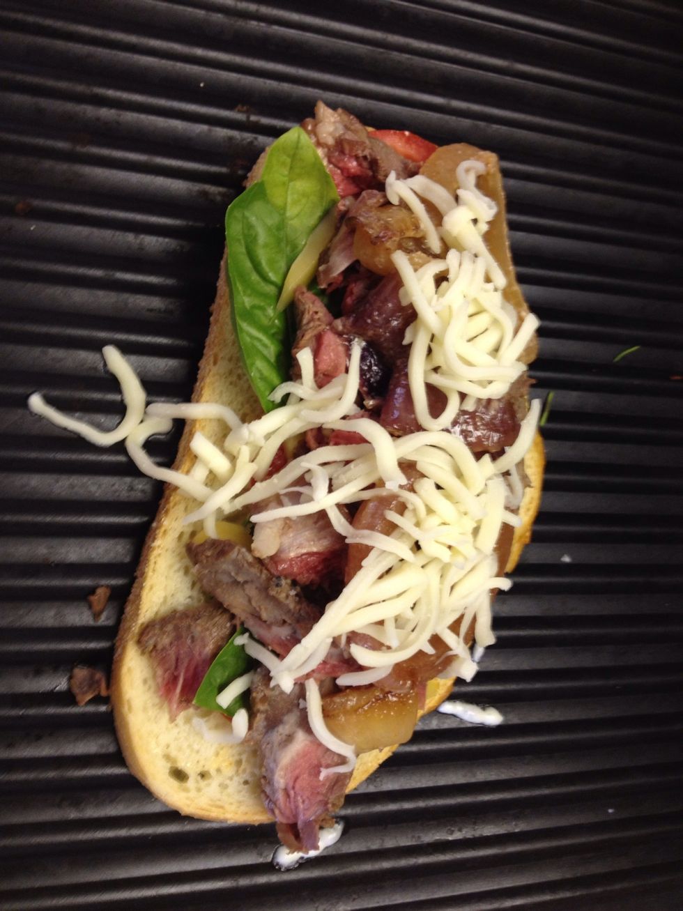 Add the steak, three cheeses and more seasonings. Be sure to layer in your onions...