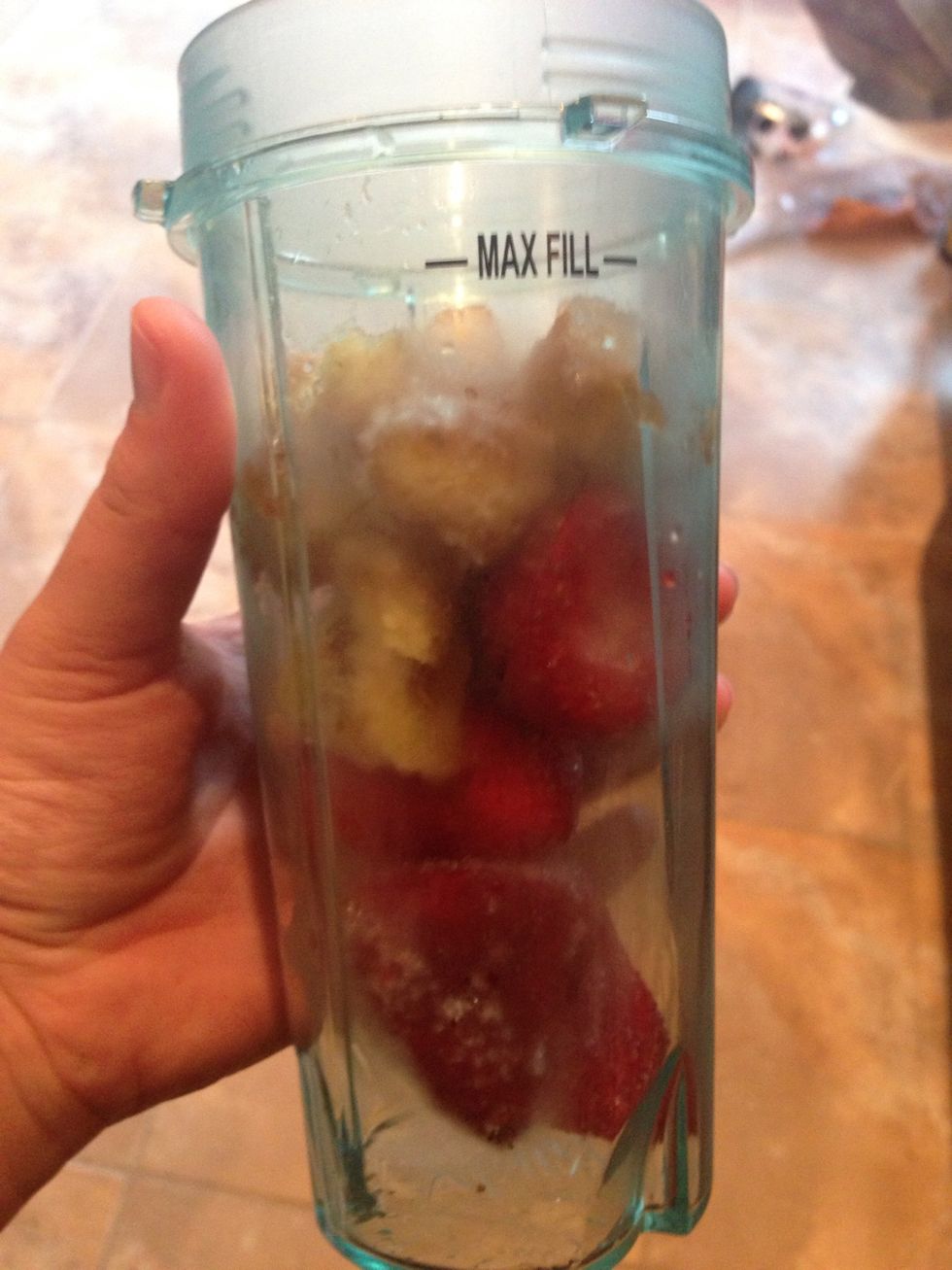 Add the strawberries and bananas to a blender. If you are using fresh fruits add some ice. I prefer using frozen.