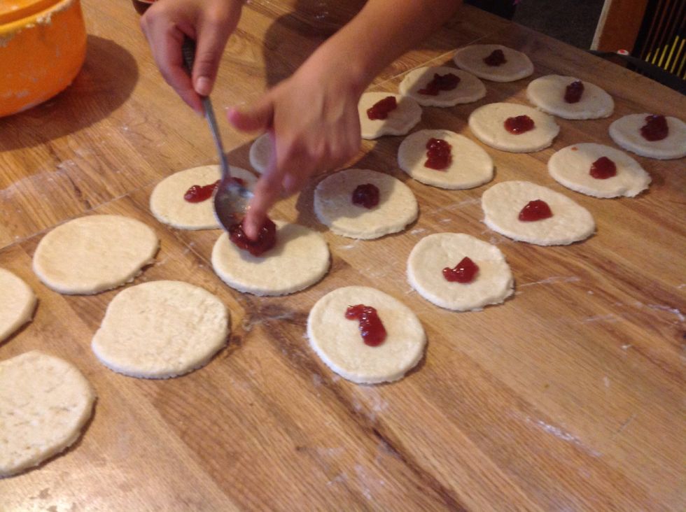 Add the strawberry jam. Don't put to much jam on it because it would melt and the empanadas would stick on the pan.