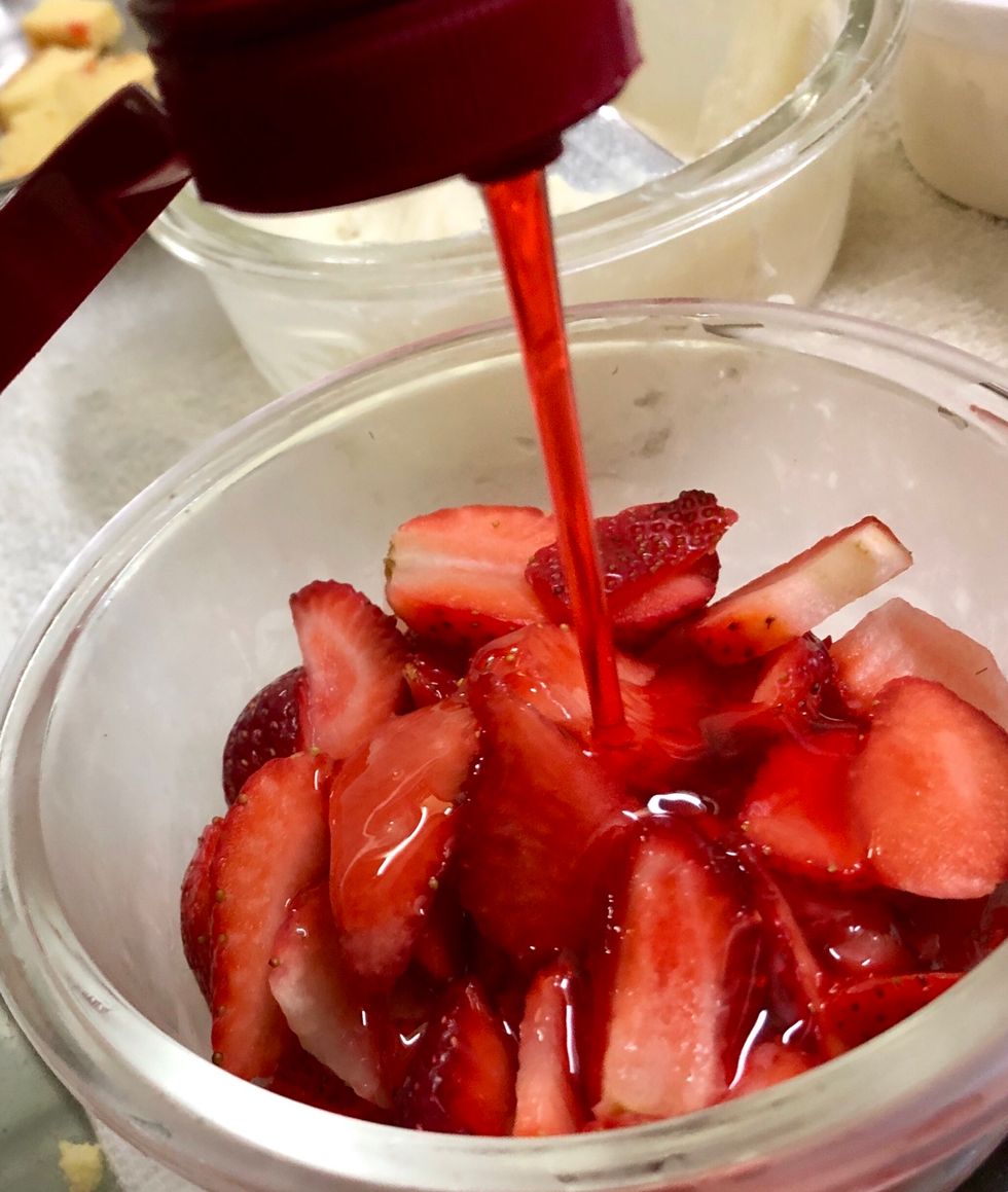 Add the strawberry syrup to the sliced berries
