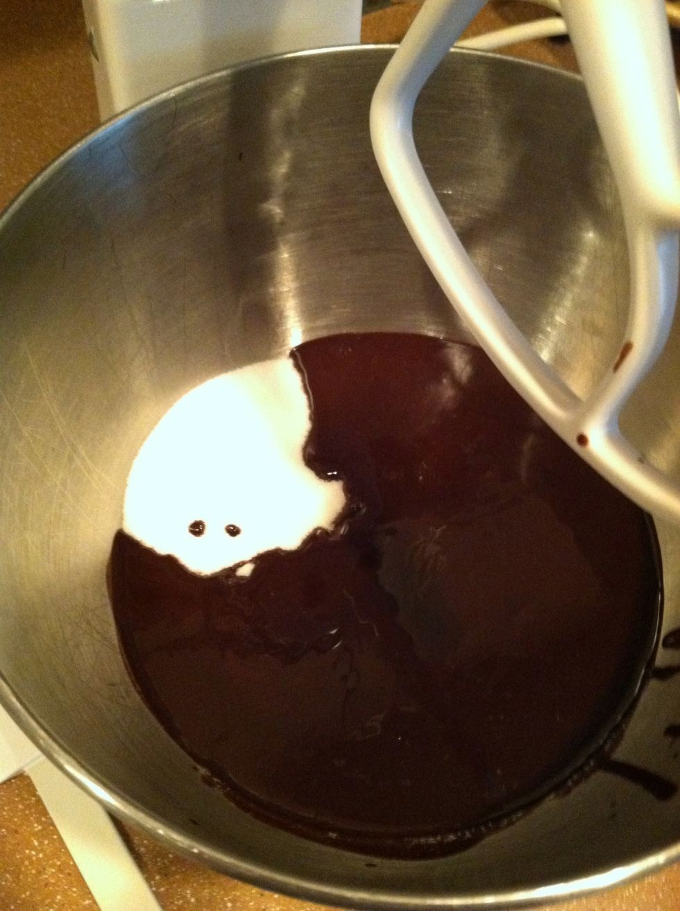 Add the sugar and cooled chocolate mixture in a mixing bowl and mix it for 5 minutes on low