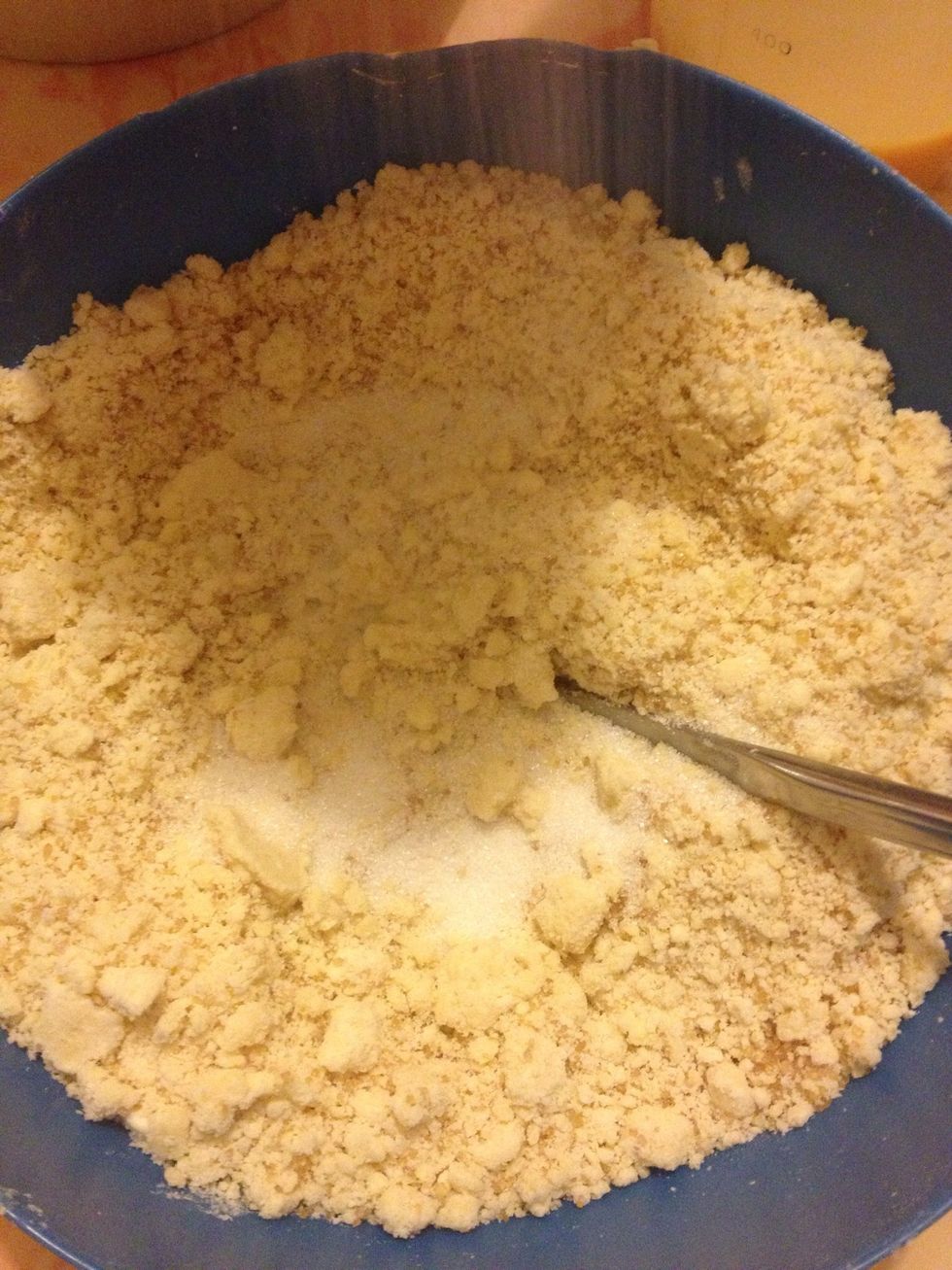 Add the sugar to the flour and butter mix.