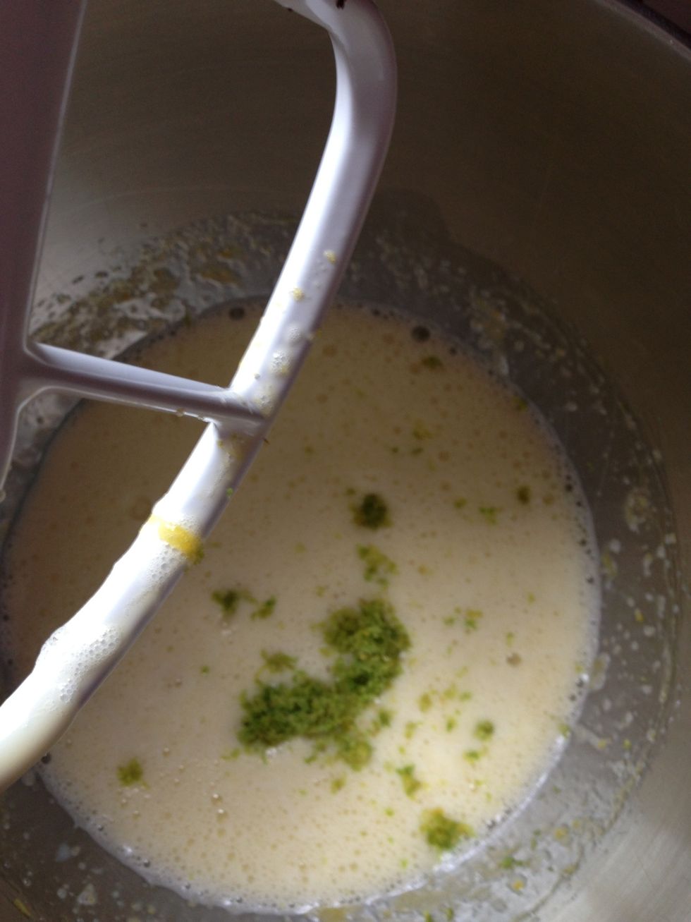 Add the sweetened condensed milk, juice, and half the zest and mix
