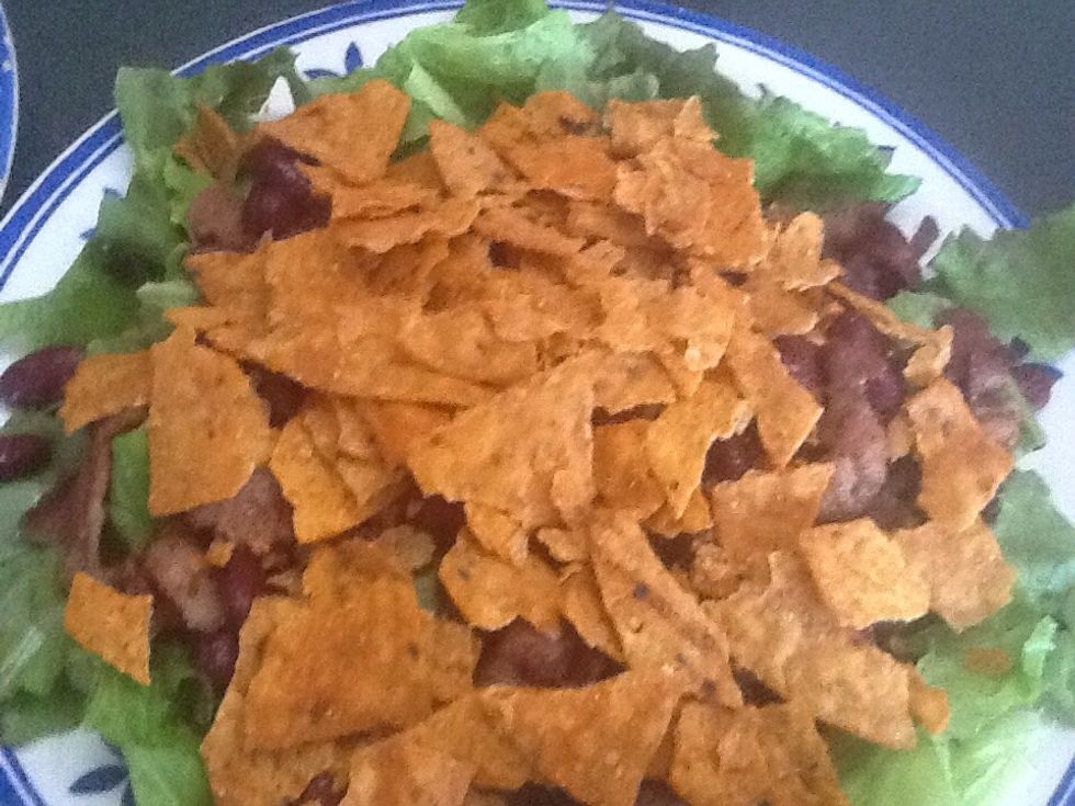 Add the tacos . Cheeses, avocados cut on slices lime juice over the avocado ,tomatoes chopped ,hard boil eggs Cut slices ,red onions olives .