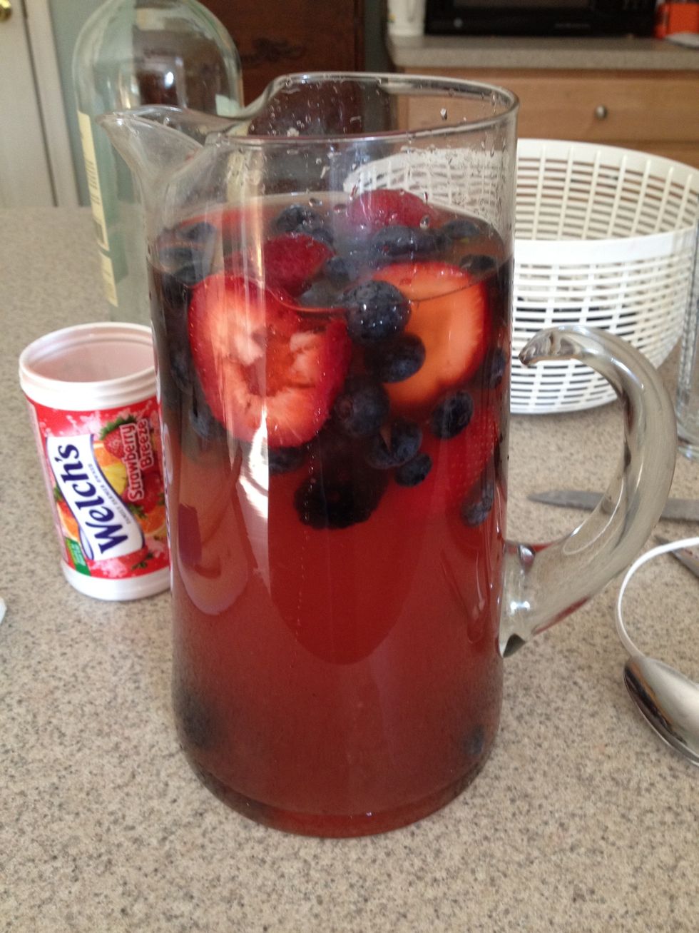 Add the thawed fruit juice concentrate and mix well. (I used strawberry apple fruit juice concentrate). Next add the fruit. Then stir and muddle the fruit a bit. Chill the sangria in the fridge!